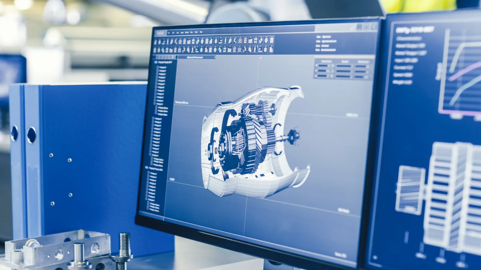 Mechanical assembly displayed on a professional CAD workstation